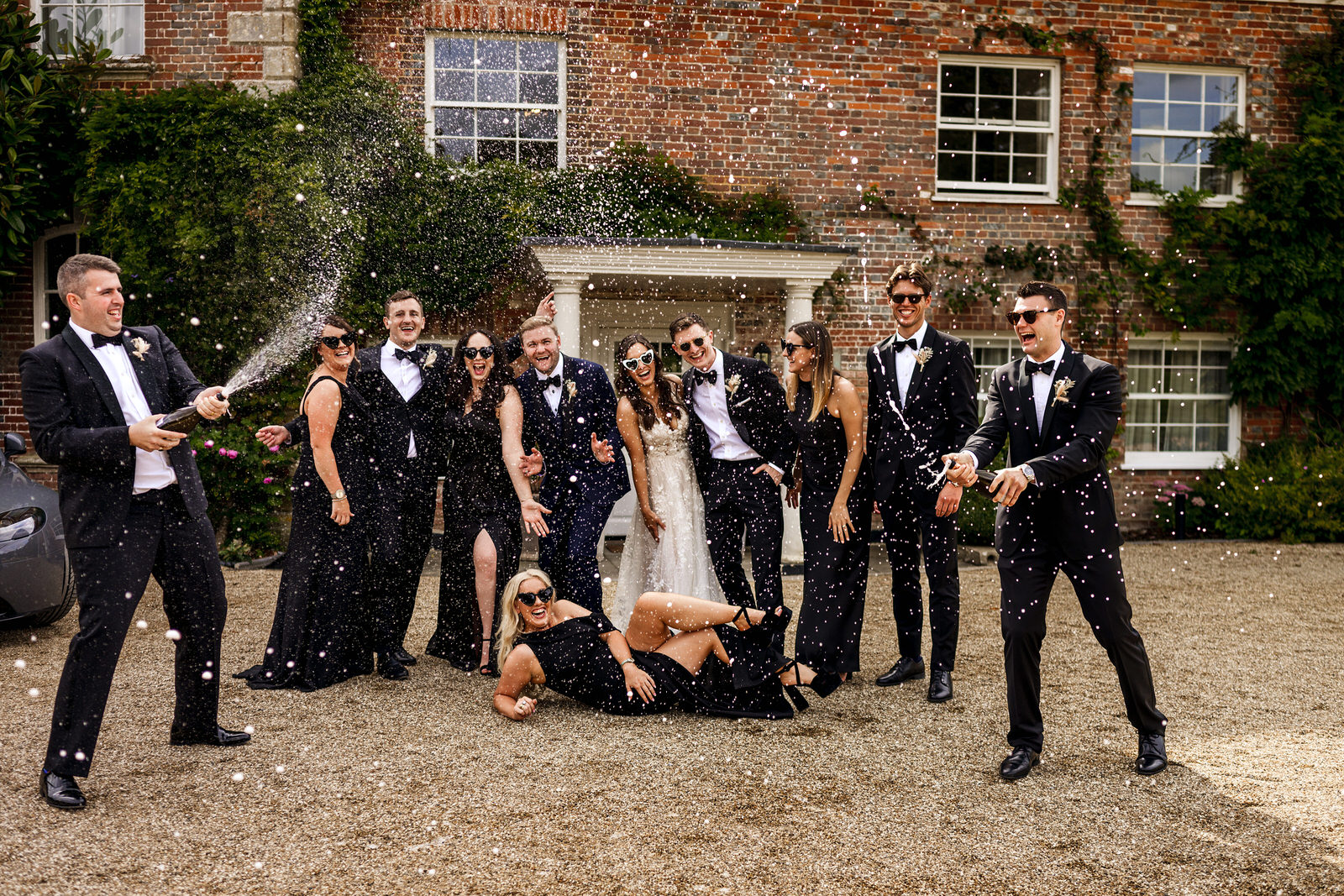 Champagne spray wedding at sunset with bridal party hot wedding trends